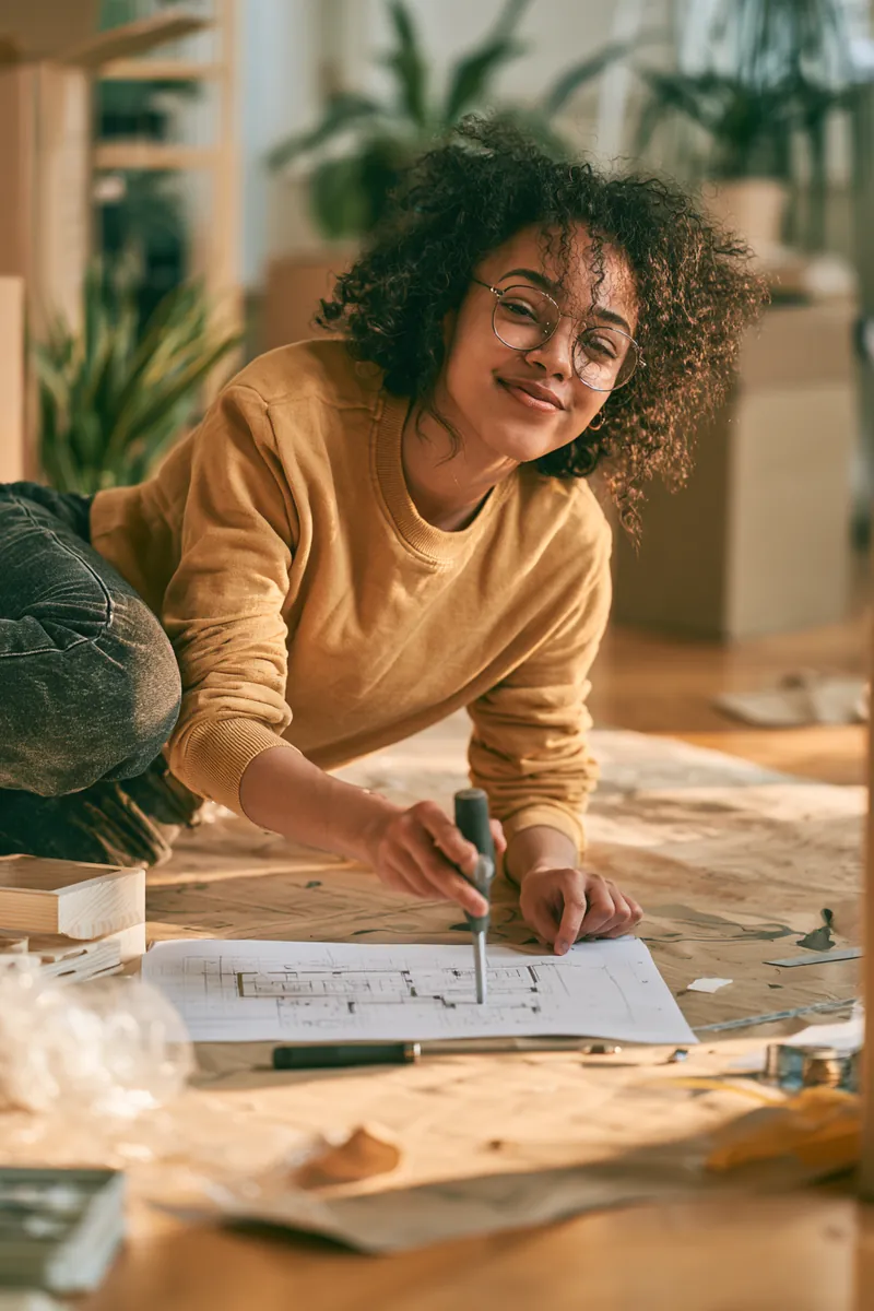 Woman assembling flat-pack furniture in her new apartment funded by a $1,500 loan